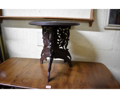 An Indian carved hardwood small circular tripod table, 37cm diameter.&nbsp; 