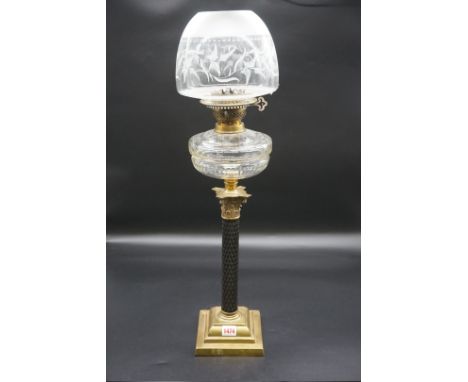 An antique brass oil lamp,&nbsp;with faceted column and Corinthian capital, height including shade 70cm. 