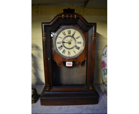 An American rosewood mantel clock, 49.5cm high, with pendulum. 