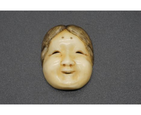 A good Japanese carved ivory Noh mask netsuke, probably Edo, depicting a lady with ribbon tied back, 4cm. 