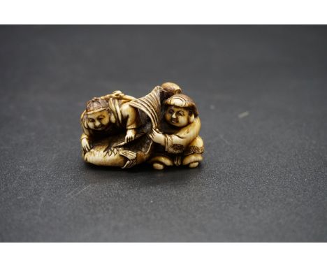 A good Japanese carved ivory netsuke, Edo, depicting Daikoku and Ebisu on a large sea bream, 4.4cm wide. 