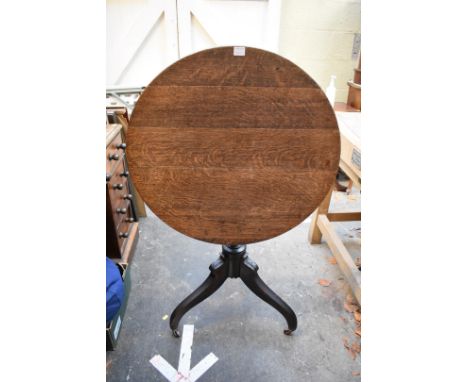 A George IV oak tilt-top tripod table,&nbsp;70.5cm diameter; together with a Victorian walnut tripod table, 42cm diameter. 