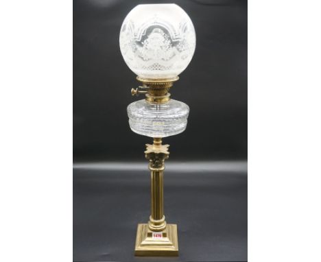 An antique brass oil lamp,&nbsp;height including shade 70cm, (repair to shade). 