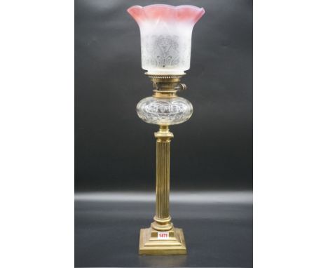 An antique brass oil lamp,&nbsp;with etched and cranberry stained shade, height including shade 65cm.&nbsp; 