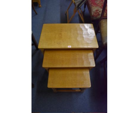 A Robert 'Mouseman' Thompson&nbsp;nest of three oak occasional tables,&nbsp;largest 61cm wide. 