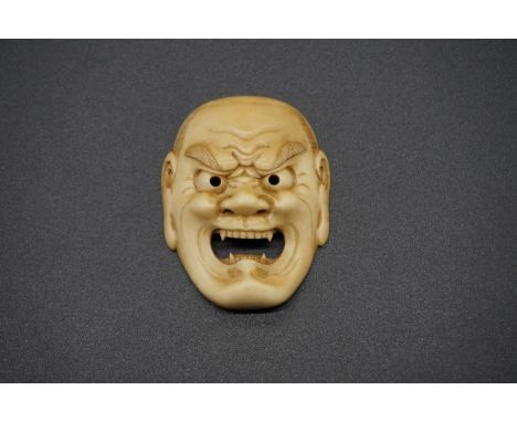 A good Japanese carved ivory Noh mask netsuke of Shikami, probably Edo, 4.2cm. 