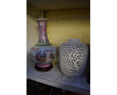 A large Chinese famille rose vase,&nbsp;38.5cm high, (s.d. to base), on wood stand; together with another Chinese blanc de ch