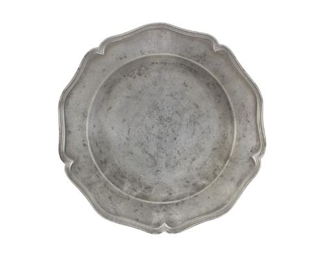 A George III pewter five lobed wavy edged armorial plate, circa 1770The flat rim with triple reeded edge, and engraved with i