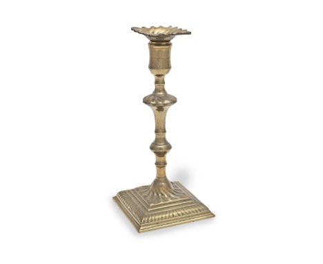 A good mid-18th century brass alloy socket candlestick, English, circa 1750With ruffled loose nozzle, the knopped stem seamed