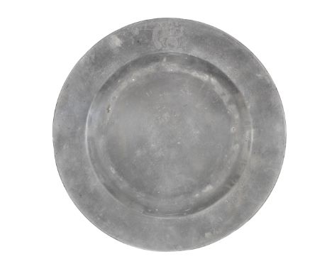 A George II pewter plain rim plate, circa 1750The rim bearing the crest of DRAKE of Buckland, Devon, with motto 'Auxilio Divi