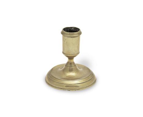 A George II brass dwarf candlestick, circa 1730-40Possibly from a toilet serviceThe socket with moulded rim and on a short wa