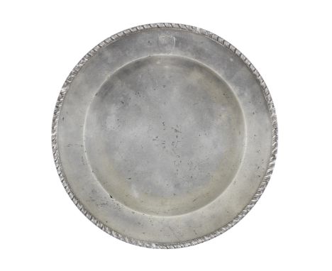 A George III pewter gadrooned-edge plate, circa 1780The rim engraved with coat of arms and crest, 'gules, a lion rampant rega