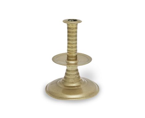 A good mid- to late 17th century brass alloy trumpet-base socket candlestick, circa 1650-1680Having a broad socket flange abo