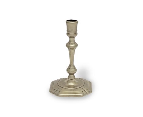 A paktong socket candlestick, circa 1750The stem cast with a rising baluster above a ball knop, and raised on a 'cut-corner' 