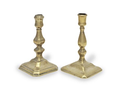 A Queen Anne/George I brass alloy socket candlestick, circa 1715With moulded and faceted socket on a faceted octagonal balust