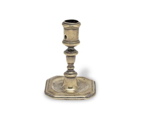A small early 18th century brass alloy socket candlestick, probably Dutch, circa 1700-1715The heavily moulded socket pierced 