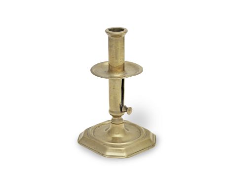 A very rare early 18th century brass socket ejector candlestick, English, circa 1700-25Seamed, the stem fitted with a drip-pa