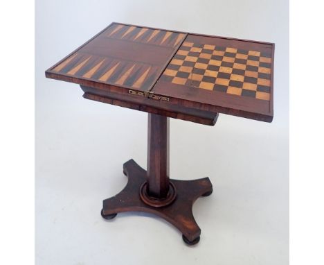 A Regency rosewood fold top games table with inlaid chess and backgammon boards al raised on column support and quadruple bas