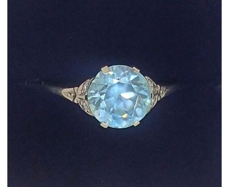 An 18 carat white gold ring set blue zircon on diamond chip shoulders, size P-Q, 2.6g 