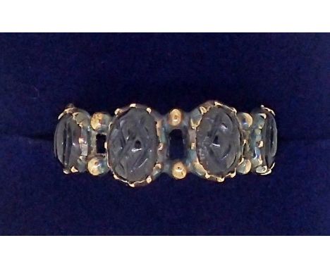 A Victorian gold ring set with carved jet beads, unmarked but tested as 15 ct gold 1.6g, size O 