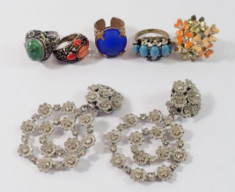 A white metal ring set turquoise and four other large dress rings and a pair of white metal large earrings 