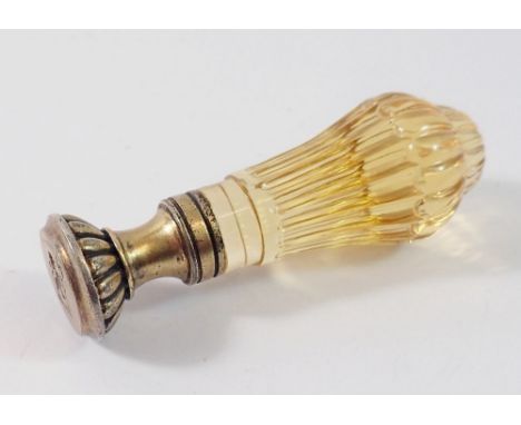 A yellow glass handled gilt metal seal with lion and axe crest 