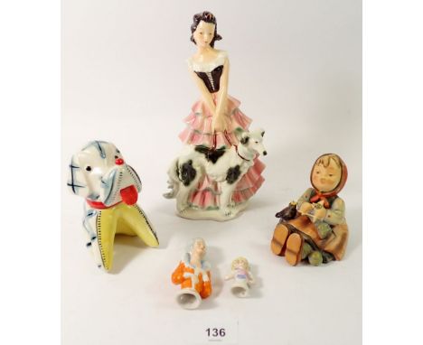 A Hummel/Goebel figure of a woman with dog, a Hummel figure Happy Pastimes plus a vintage china novelty dog with tape measure