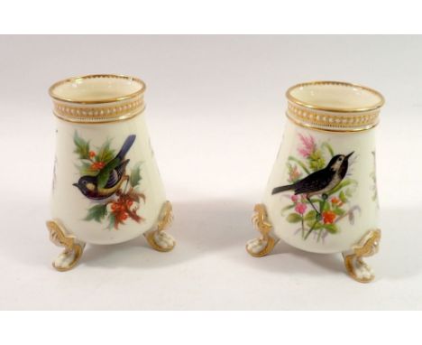 A pair of Royal Worcester vases painted birds in sprays of flowers and berries, by John Hopewell on triple scroll feet circa 
