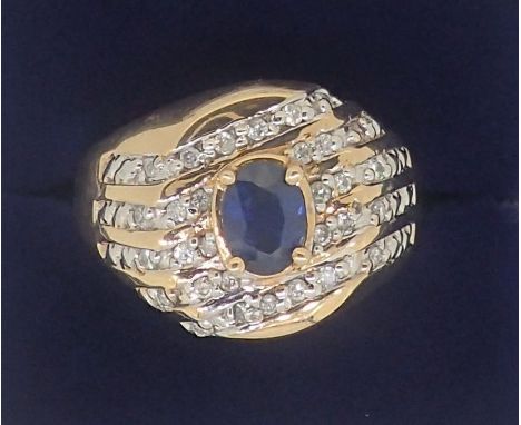 A 10k gold ring set oval cut sapphire in five diagonal rows of channel set diamonds, 5.6g, size W 