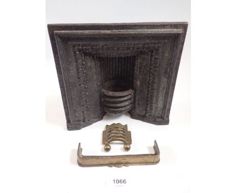 A 19th century salesman's miniature cast iron fireplace with brass fire grate and fender, 20.5cm tall 