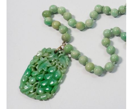 A fine Chinese jade bead necklace with vine carved decorative panel, the panel has been broken and glued - panel 5 x 3.8cm - 