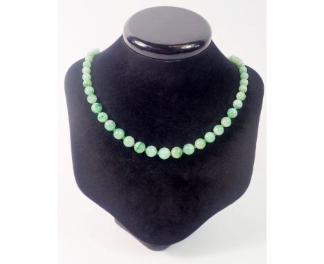 A jade bead necklace with 9 carat gold clasp set chip diamonds and emeralds 
