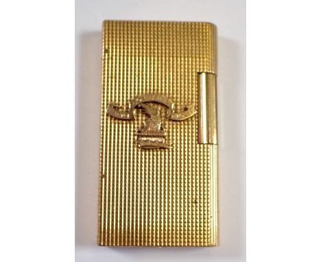 A Caran D'ache gold plated lighter with applied crest 