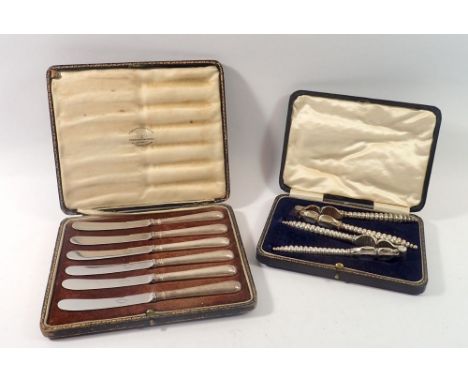 A set of six silver handled tea knives, cased, Birmingham 1903 and a pair of silver plated nutcrackers, cased 