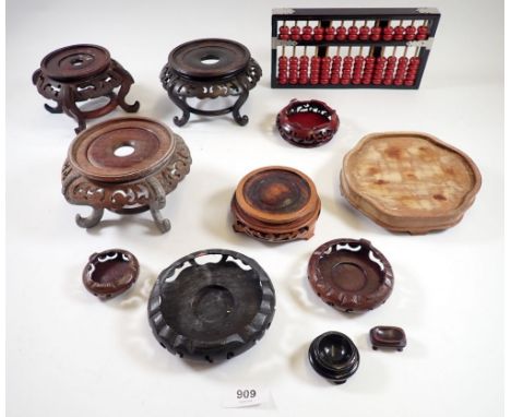 A collection of oriental items including various wooden carved stands, Chinese abacus etc. 