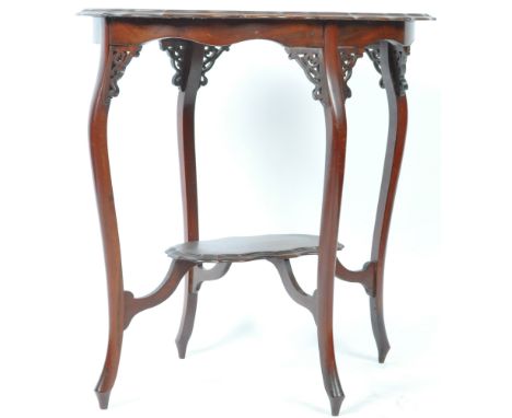 An antique 19th Century Victorian English mahogany scalloped edge side / lamp occasional table of oval form with a serpentine