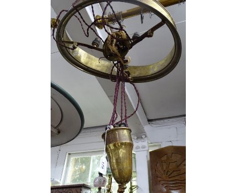 A brass rise and fall ceiling light shade frame.