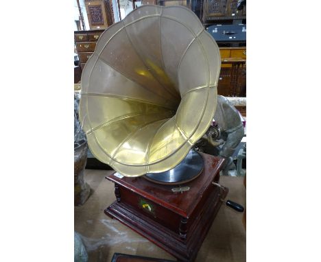 A HMV wind-up record player with brass horn.