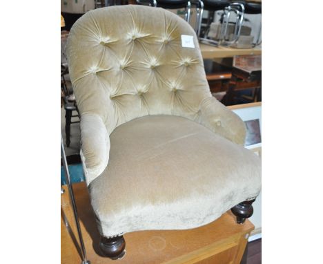 A small Victorian button back upholstered armchair.