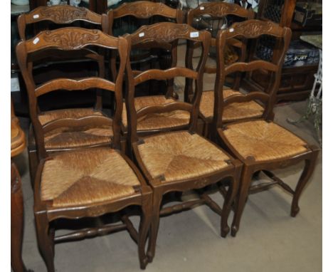 A set of 6 French stained beech ladder back chairs with drop-in rush seats.