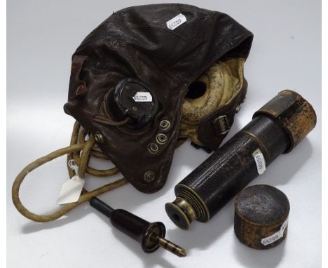 A leather helmet and a brass telescope by Lennie of Edinburgh.