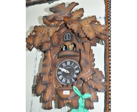 A Black Forest design cuckoo clock with dancing figure automaton, (quartz movement), height 65cm.