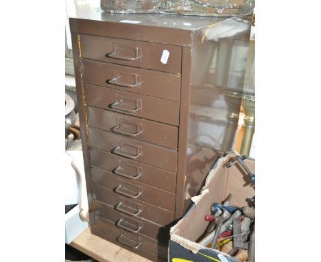 A painted metal 10-drawer filing cabinet, with some dentistry tools, width 28cm.