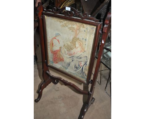 A Victorian mahogany firescreen with an inset woolwork panel, width 61cm.