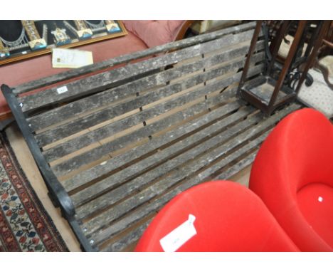 A hardwood slatted garden bench with wrought iron ends, length 157cm