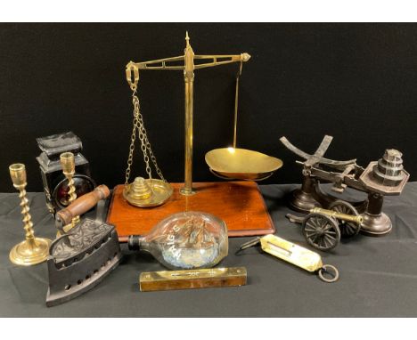 A pair of brass twist stemmed candlesticks,20cm high, bike lamp, weighing scales; etc 