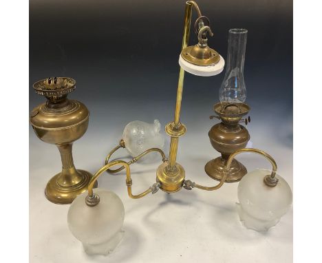 An Edwardian brass oil lamp, another, three arm ceiling light, with frosted glass shades (3) 