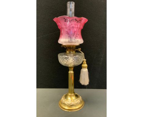 A Victorian cranberry and clear glass paraffin/oil lamp, Art Nouveau pink and clear glass shade, cut clear glass reservoir, b