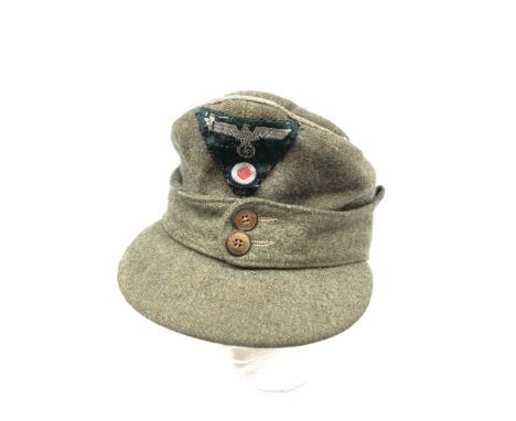 German Wehrmacht M43 field cap, green wool with one piece eagle and cockade insignia and two button front, interior stencille