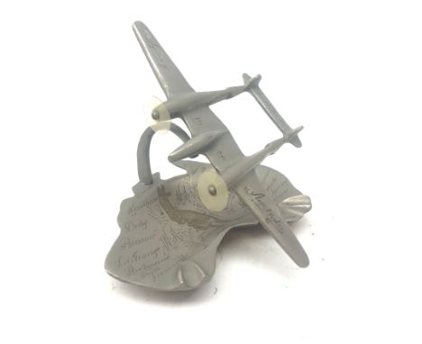 Metal model of an twin prop aeroplane inscribed 'Australia, South Pacific, 1946' mounted on an ashtray in the shape of Austra